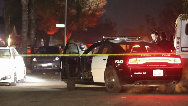 Photo police work at the scene of a mass shooting in southeast Fresno on Nov. 17.