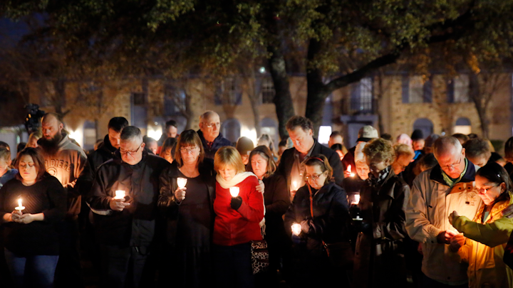 Church and community members gathered outside the West Freeway Church of Christ in Fort Worth for a candlelight vigil, Monday evening, Dec. 30, 2019. A gunman shot and killed two parishioners before an armed security officer returned fire, killing him yesterday during their service.