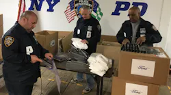 NYPD officers sort through the 1,500 plastic face shields that were donated by the Ford Motor Company to aid officers on the front lines in the fight against the coronavirus.
