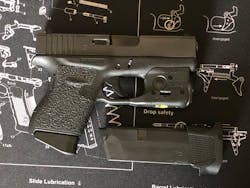 The Glock 43 with standard magazine inserted and Streamlight TLR-6 mounted. Magazine with +2 floorplate for backup shown.
