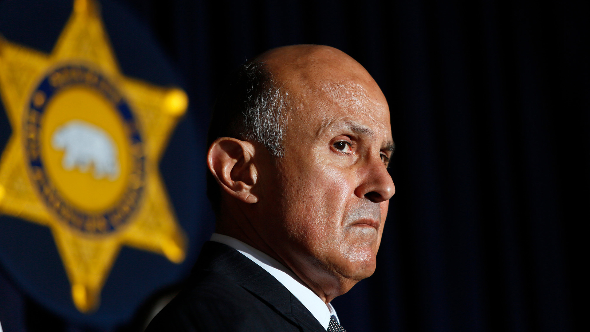 In this file photo, Los Angeles County Sheriff Lee Baca and detectives from the Major Crimes Bureau address an April 2013 press conference about an investigation into a bank heist crew that accessed the roofs of banks with power tools to get into cement vaults. A judge has denied a request from disgraced former Los Angeles County Sheriff Lee Baca to be released from federal prison in Texas because of the coronavirus pandemic.