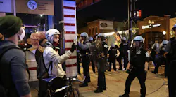 Protesters and police stand off outside a McDonald's at North Wells Street and West North Avenue in Chicago on May 31, 2020.