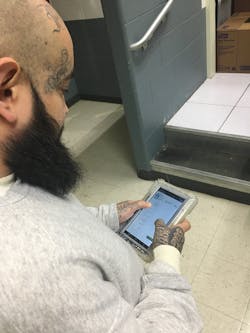 Jesus Villegas, an incarcerated individual at the Kendall County Sheriff's Office in Illinois, uses the photo attachment featured of the eMessaging application on SecurueView Tablets from Securus Technologies to view pictures of photos of family and friends. Jesus Villegas, an incarcerated individual at the Kendall County Sheriff's Office in Illinois, uses the photo attachment featured of the eMessaging application on SecurueView Tablets from Securus Technologies to view pictures of photos of family and friends.