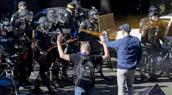 Seattle Police use pepper spray on protesters along Harvard Avenue behind Seattle Central College as they advance their line during a 'Youth Day of Action and Solidarity with Portland' on Saturday, July 25, 2020.