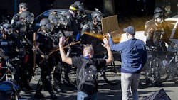 Seattle Police use pepper spray on protesters along Harvard Avenue behind Seattle Central College as they advance their line during a 'Youth Day of Action and Solidarity with Portland' on Saturday, July 25, 2020. Seattle Police use pepper spray on protesters along Harvard Avenue behind Seattle Central College as they advance their line during a 'Youth Day of Action and Solidarity with Portland' on Saturday, July 25, 2020.