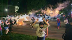 Tear gas lands around protesters after they refused to listen to police demands to disperse near the courthouse in Kenosha, Wisconsin on Tuesday, August 25, 2020. Tear gas lands around protesters after they refused to listen to police demands to disperse near the courthouse in Kenosha, Wisconsin on Tuesday, August 25, 2020.