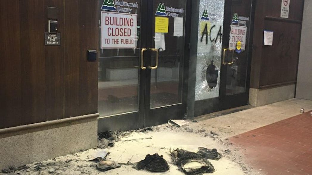 A demonstration by protesters in Portland began peacefully Tuesday night, but again turned violent as members of the group began to vandalize and set fire to the Multnomath Building.