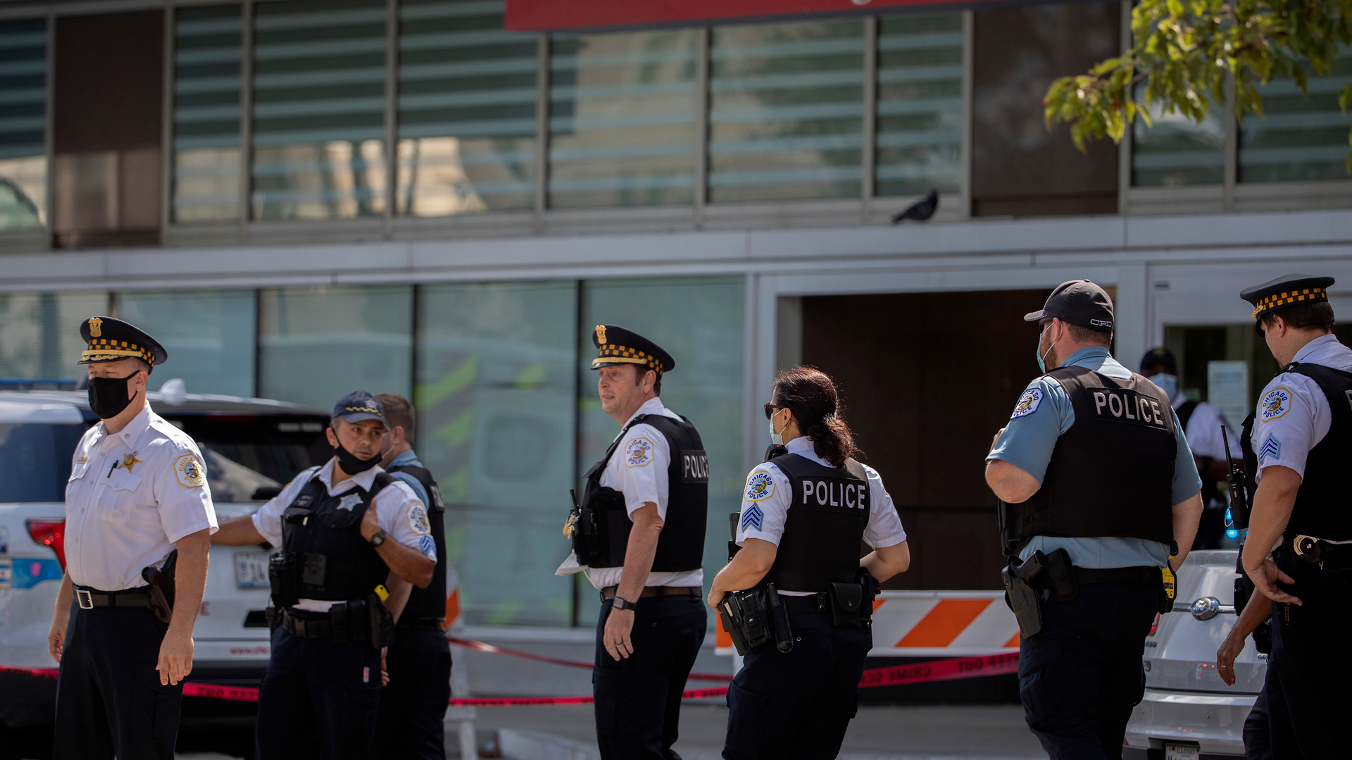 Chicago police officers gather outside the emergency area of Stroger Hospital after two Chicago police officers were wounded in a shooting during a traffic stop in the Homan Square neighborhood early Sunday, August 30, 2020, in Chicago.