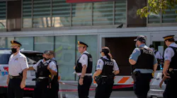 Chicago police officers gather outside the emergency area of Stroger Hospital after two Chicago police officers were wounded in a shooting during a traffic stop in the Homan Square neighborhood early Sunday, August 30, 2020, in Chicago.