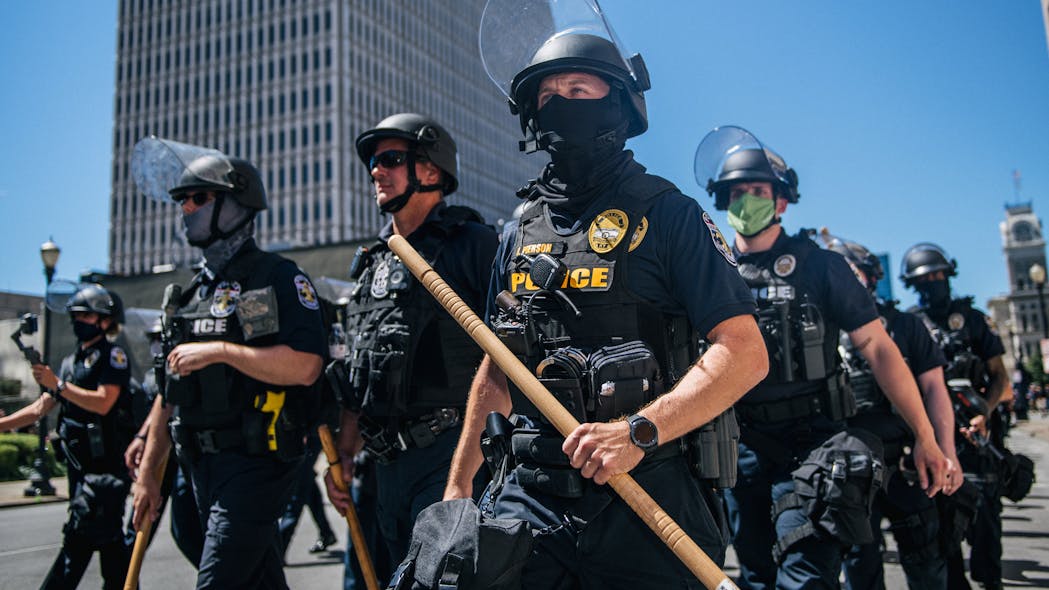 In this file photo, Louisville Metro police officers arrive to defuse confrontations in front of the Louisville Metro Hall on Sep. 5, 2020 in Louisville, KY.