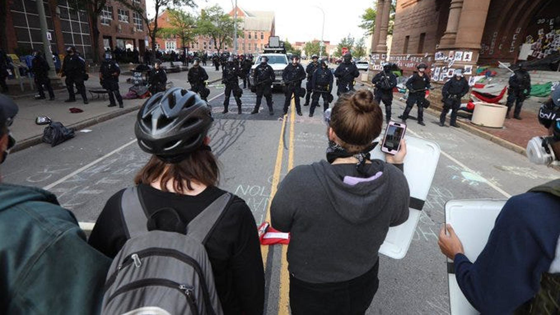 Protesters face off with Rochester police officers in front of City Hall on Wednesday.