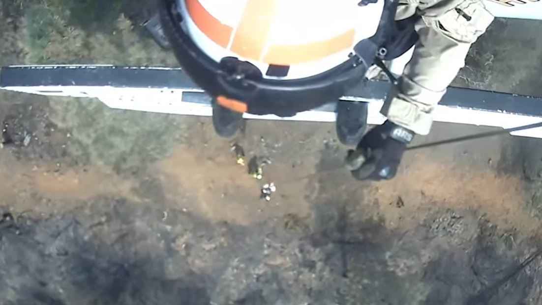 Newly released video footage shows a California Highway Patrol helicopter crew rescue four injured U.S. National Guard members inside firelines this weekend.