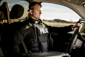 Properly fit body armor has to provide maximum coverage but also take into consideration the amount of time officers spend sitting in their patrol vehicle. Seen here is Hard Core PT overt/outer carrier from Armor Express.
