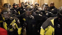 Riot police clear the hallway inside the Capitol on Wednesday, Jan. 6, 2021, in Washington, D.C.