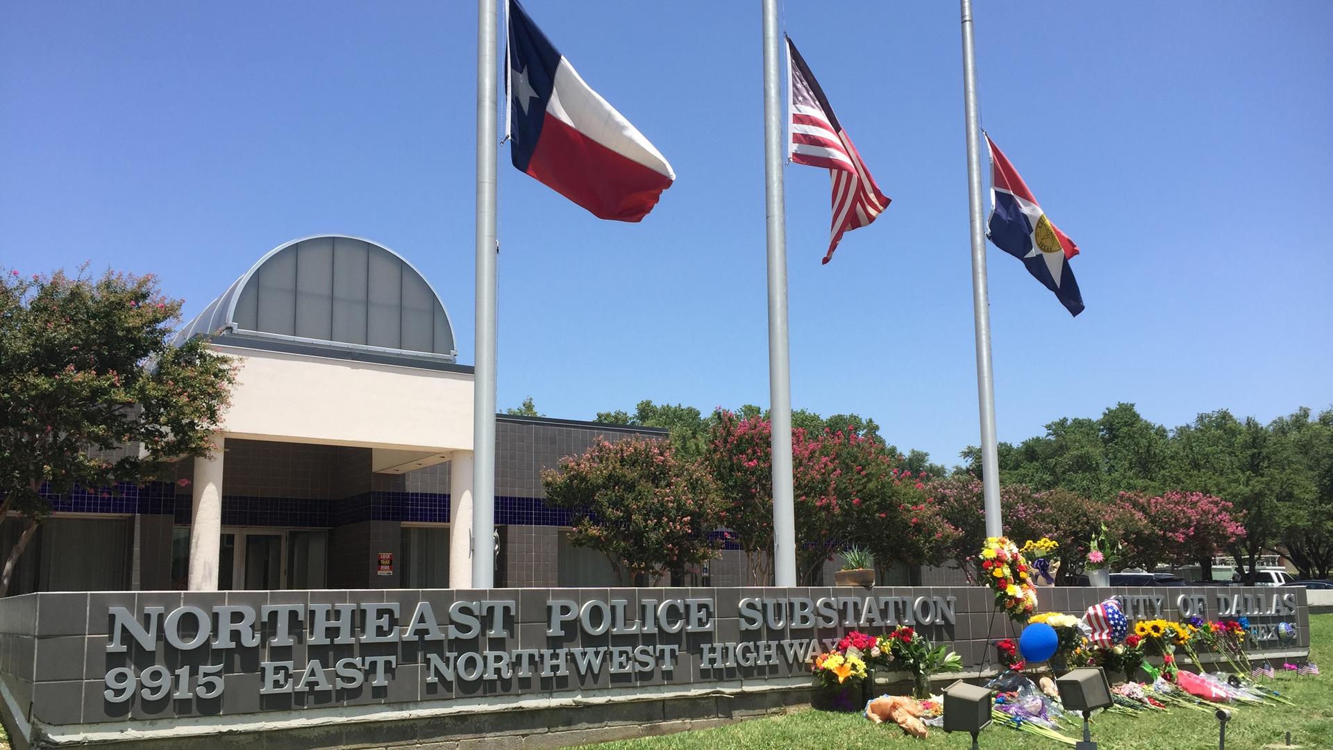 A police precinct in city of Dallas receives flowers as the city mourns the loss of police officers killed in a mass shooting on July 7, 2016.