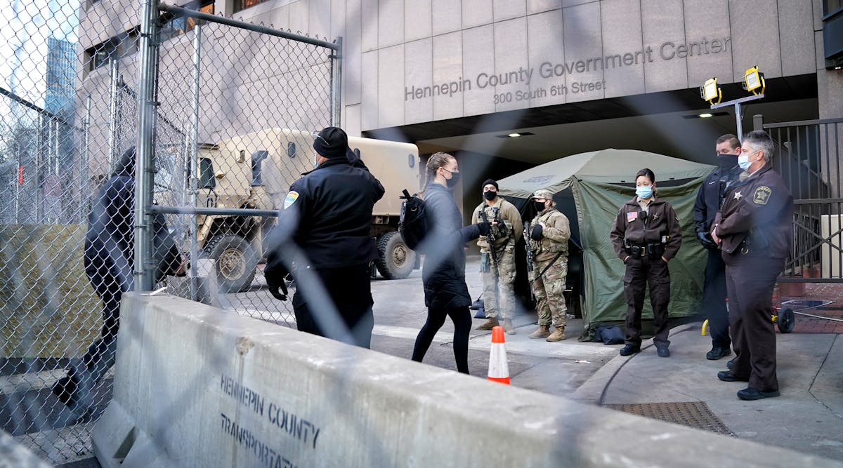 Pedestrians were cleared one at a time through one gate outside the Hennepin County Courthouse, site of the trial of former Minneapolis police officer Derek Chauvin in the death of George Floyd.