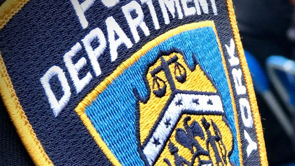 A NYPD officer was saved by his bulletproof vest Sunday night after a gunman shot him in the chest at a Brooklyn apartment building