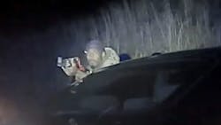 In a still from video taken by a state trooper's camera, Timothy Carruth fires an AK-47 at the trooper after a chase ended with Carruth wrecking his car. In a still from video taken by a state trooper's camera, Timothy Carruth fires an AK-47 at the trooper after a chase ended with Carruth wrecking his car.