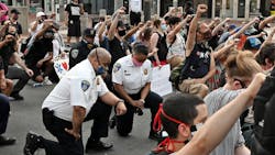 Baltimore City Police Commissioner Michael Harrison takes a knee with protestors on Hopkins Plaza on June 4, 2020. Baltimore City Police Commissioner Michael Harrison takes a knee with protestors on Hopkins Plaza on June 4, 2020.