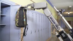 Telerob's telemax EVO PLUS is seen lifting a backpack inside a school. Telerob's telemax EVO PLUS is seen lifting a backpack inside a school.