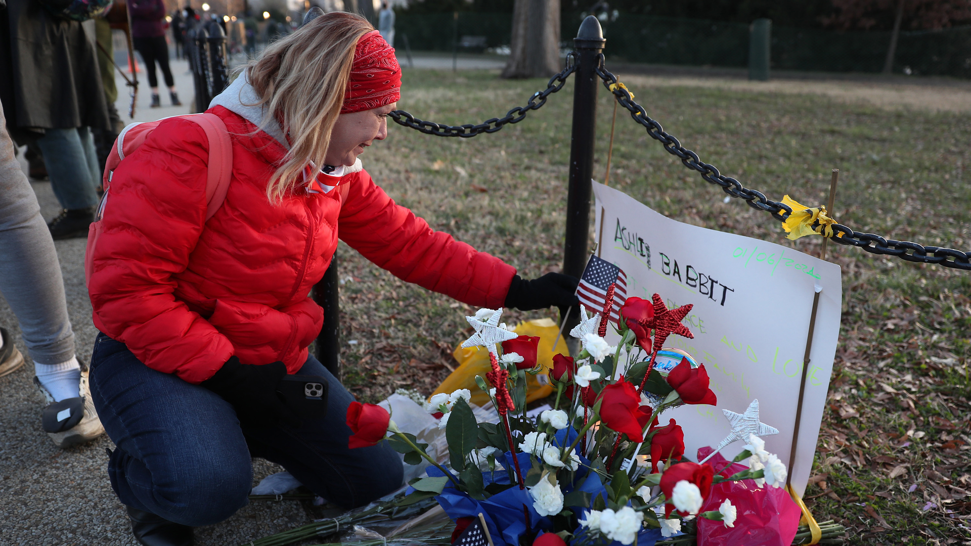 Melody Black becomes emotional as she visits a memorial setup near the U.S. Capitol Building for Ashli Babbitt, who was killed in the building after a pro-Trump mob broke in, on Jan. 6.
