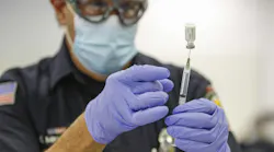 Firefighter-paramedic Mitch Mendler prepares a Pfizer COVID-19 vaccine for a recipient at the San Diego Fire-Rescue Training Facility on Dec. 31.