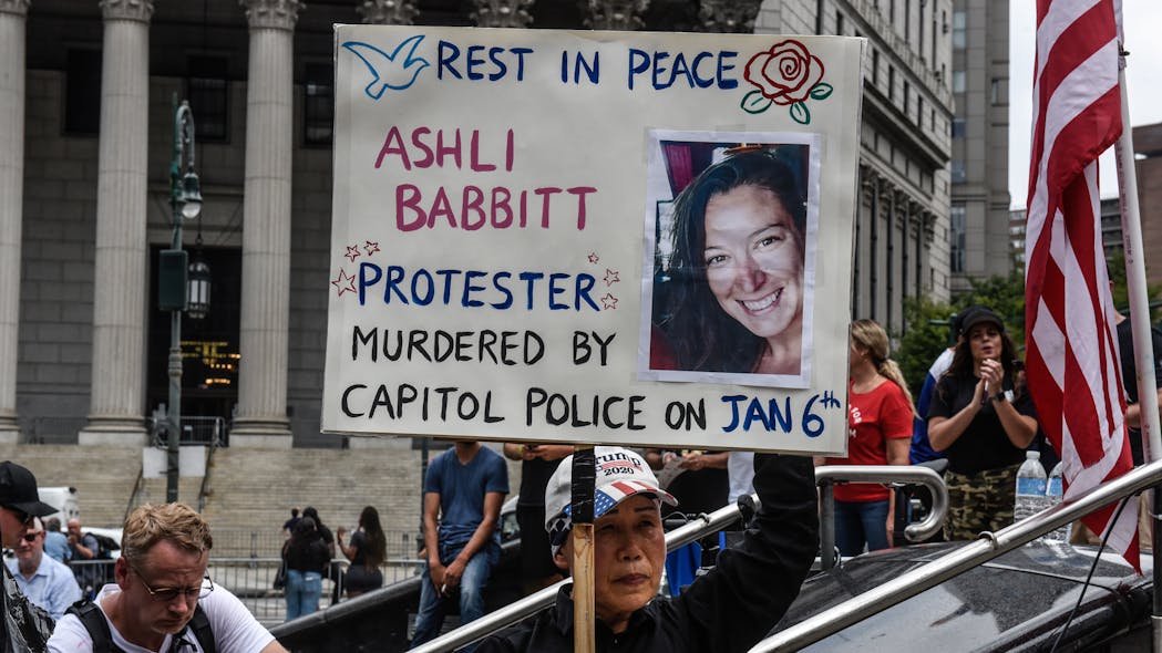 A protester holds a sign about Ashli Babbitt while participating in a political rally on July 25 in New York City.