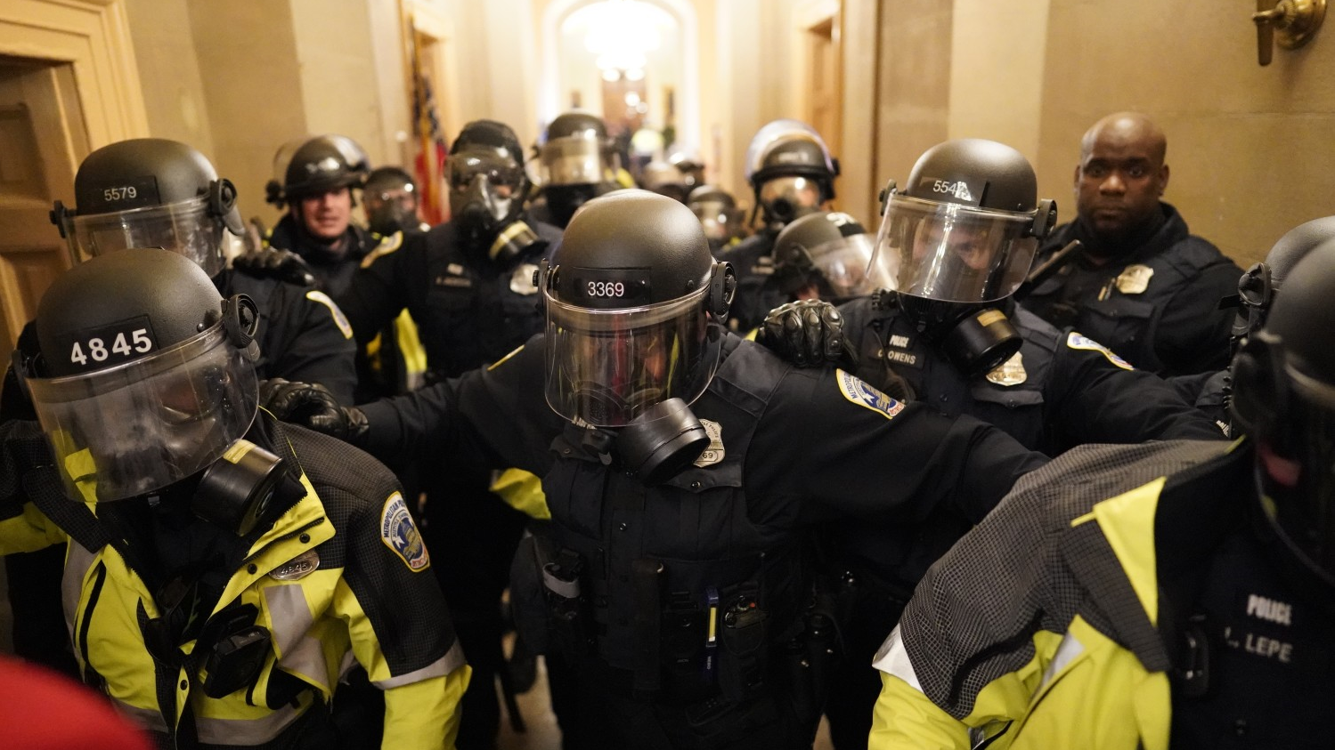 Riot police clear the hallway inside the Capitol on Jan. 6 in Washington, DC.