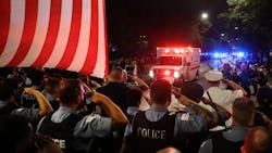 Chicago police officers salute as the ambulance carrying the body of fellow Officer Ella French arrives at the Cook County Medical Examiner in the early Sunday. Chicago police officers salute as the ambulance carrying the body of fellow Officer Ella French arrives at the Cook County Medical Examiner in the early Sunday.