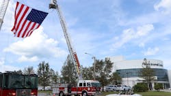 A giant American flag flies over Beach Street in front of the News Journal Center on Sunday during the viewing for slain Daytona Beach, FL, Police Officer Jason Raynor. A giant American flag flies over Beach Street in front of the News Journal Center on Sunday during the viewing for slain Daytona Beach, FL, Police Officer Jason Raynor.