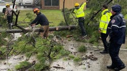 St. Tammany Parish, LA, Fire Protection District #1 firefighters deal with a downed tree in Slidell in the aftermath of Hurricane Ida on Monday.