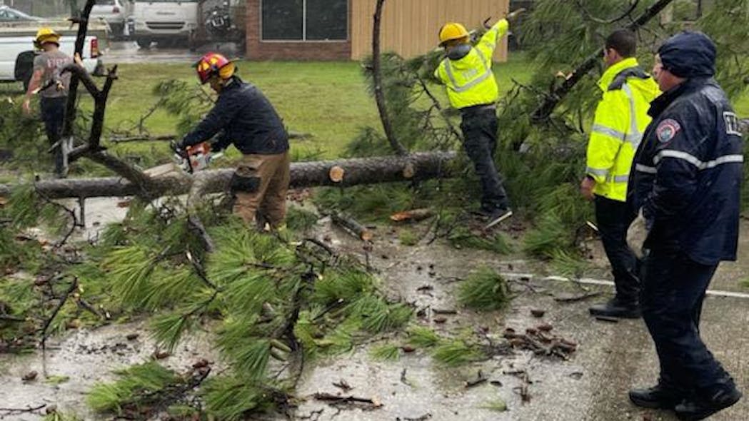 St. Tammany Parish, LA, Fire Protection District #1 firefighters deal with a downed tree in Slidell in the aftermath of Hurricane Ida on Monday.