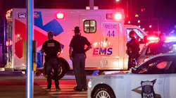 An ambulance drives toward a hospital Wednesday at the scene of a shooting that reportedly wounded an Indianapolis police and critically injured a woman and girl.
