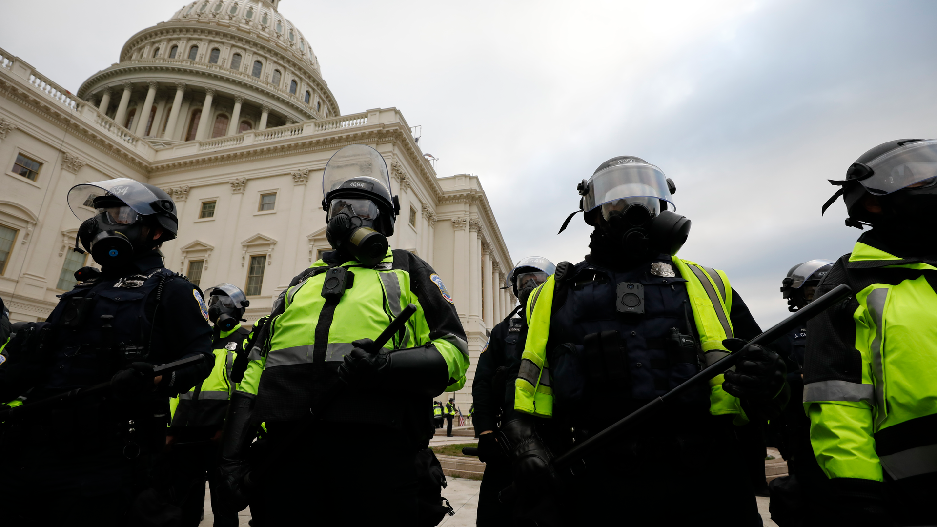 Police officers in riot gear stand guard while supporters of President Donald Trump protest on the steps of the U.S. Capitol building on Capitol Hill in Washington, D.C., on Jan. 6.
