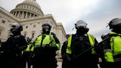 Police officers in riot gear stand guard while supporters of President Donald Trump protest on the steps of the U.S. Capitol building on Capitol Hill in Washington, D.C., on Jan. 6. Police officers in riot gear stand guard while supporters of President Donald Trump protest on the steps of the U.S. Capitol building on Capitol Hill in Washington, D.C., on Jan. 6.