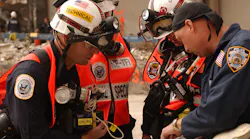 Urban Search and Rescue team members review site maps at the World Trade Center in New York City on September 28, 2001.