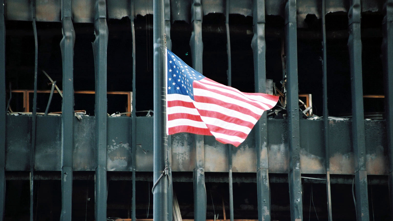 An American flag is flying at half mast above the rubble of the World Trade Center in New York City on September 27, 2001.
