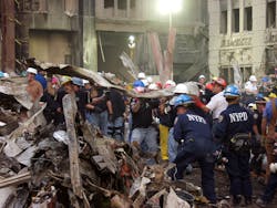New York police officers work around the clock to clear debris and search for victims at the World Trade Center crash site in New York City on September 21, 2001.