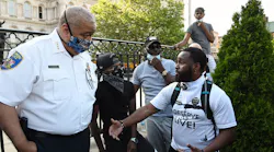 Baltimore Police Commissioner Michael Harrison listens to a question from Wesley Hawkins of The Nolita Project at a rally at CIty Hall to remember George Floyd and other African Americans killed by police and demand change. June 4, 2020.