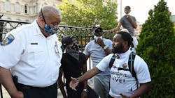 Baltimore Police Commissioner Michael Harrison listens to a question from Wesley Hawkins of The Nolita Project at a rally at CIty Hall to remember George Floyd and other African Americans killed by police and demand change. June 4, 2020. Baltimore Police Commissioner Michael Harrison listens to a question from Wesley Hawkins of The Nolita Project at a rally at CIty Hall to remember George Floyd and other African Americans killed by police and demand change. June 4, 2020.