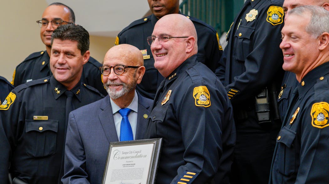 Tampa Police Chief Brian Dugan (center right) poses for a photo with Councilman Charlie Miranda and members of his command staff after Miranda presented Dugan with a commendation for his 31 years of service to the department on Sept. 2.