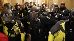 Riot police clear the hallway inside the Capitol on Jan. 6 in Washington, D.C.