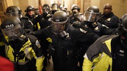 Riot police clear the hallway inside the Capitol on Jan. 6 in Washington, D.C.