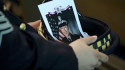 A Chicago police officer holds an image of Officer Ella French in his hat during her funeral service Aug. 19 at St. Rita of Cascia Shrine Chapel. A Chicago police officer holds an image of Officer Ella French in his hat during her funeral service Aug. 19 at St. Rita of Cascia Shrine Chapel.