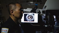 Evidence technician Roger Kono analyzes ballistic evidence at the Chicago police firearms laboratory at the Homan Square police facility on June 9. Evidence technician Roger Kono analyzes ballistic evidence at the Chicago police firearms laboratory at the Homan Square police facility on June 9.