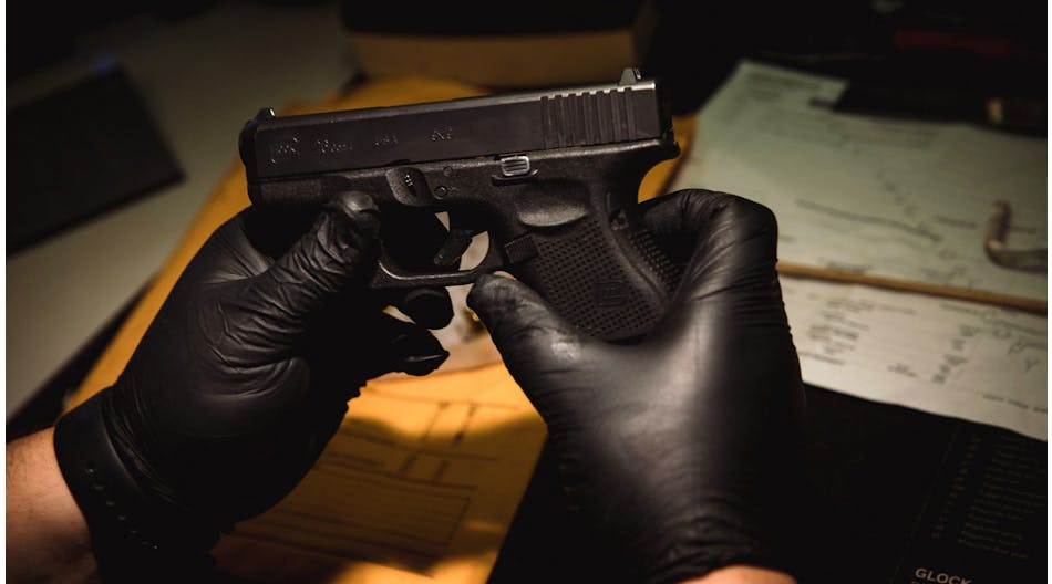 Evidence technician Christopher Lenti inventories a Glock 9mm at the Chicago police firearms laboratory at the CPD Homan Square police facility on June 9.
