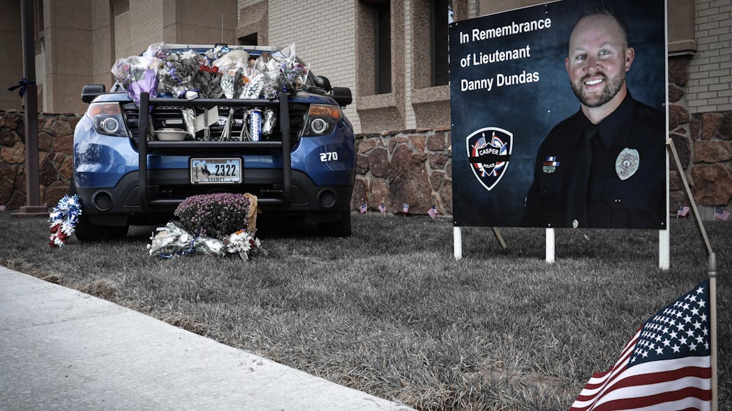 A memorial for Casper, WY, Police Lt. Dan Dundas, who took his life Monday, was erected outside the department and includes his squad car.