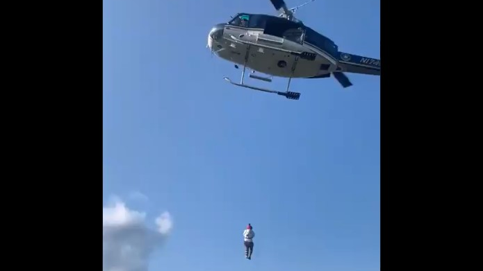 A New York State Police helicopter rescues an injured hiker from a hard-to-reach area of Crane Mountain in the Adirondacks on Sept. 12.