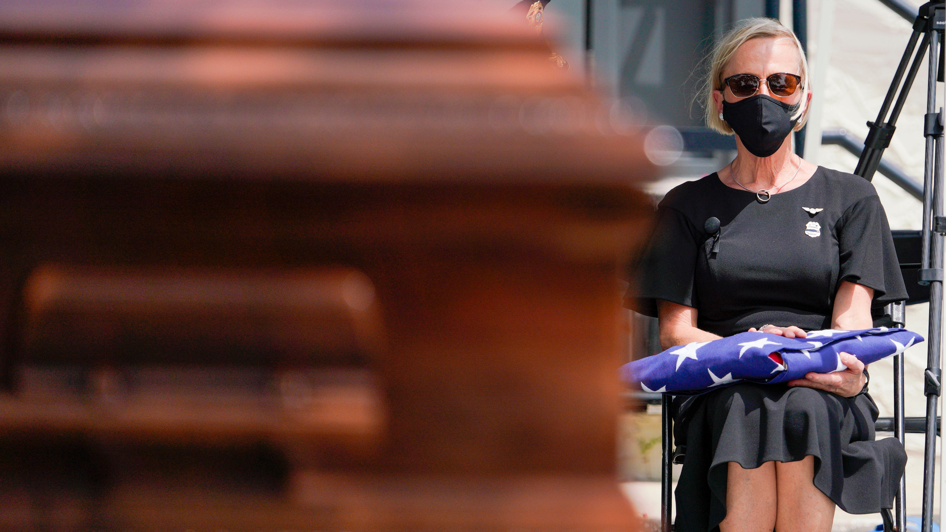 Karen Weiskopf, the widow of St. Petersburg, FL, Police Officer Michael Weiskopf, holds the ceremonial flag in her lap during her husband&rsquo;s funeral at The Coliseum on Tuesday. Weiskopf was unvaccinated and died from complications from COVID-19.