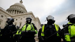 Police officers in riot gear stand guard while supporters of President Donald Trump protest on the steps of the U.S. Capitol building in Washington, D.C., on Jan. 6. Police officers in riot gear stand guard while supporters of President Donald Trump protest on the steps of the U.S. Capitol building in Washington, D.C., on Jan. 6.